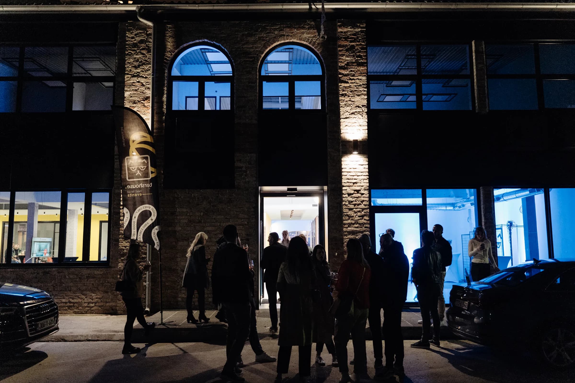 tershouse Kolodvorska 12, Sarajevo at night — members gathered outside the restored 1890 railway workshop